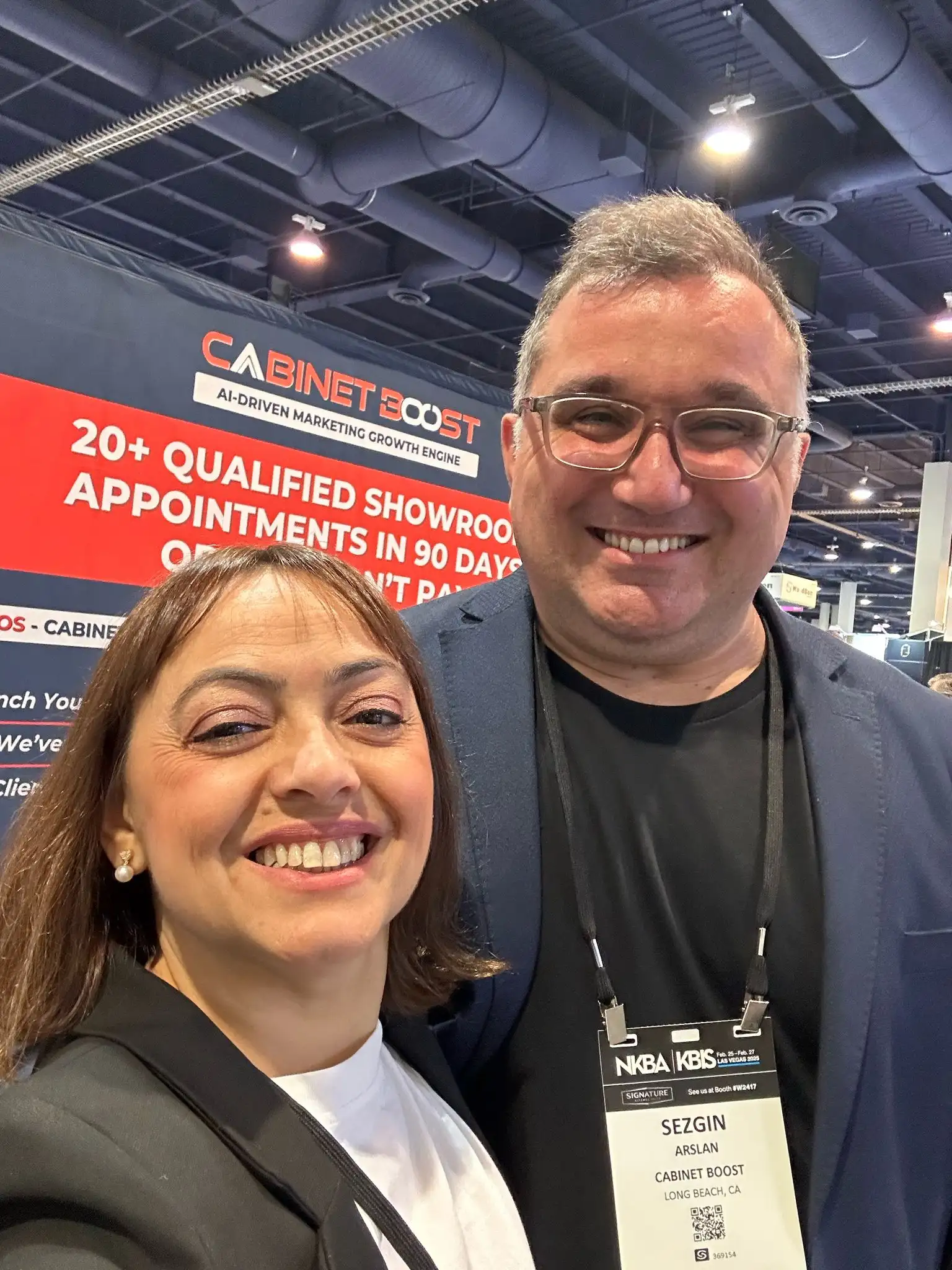 CabinetBoost founder Sezgin Arslan with a KBIS 2025 attendee at Booth SL3205, Las Vegas Convention Center, February 25, 2025 — NKBA badge visible